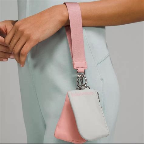 The true identity card case has slots on the outside and can be attached to the never lost keychain. . Dual pouch wristlet lululemon